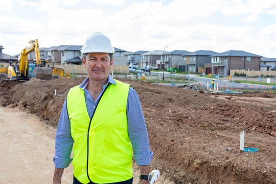 Property developer standing at front of housing estate