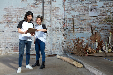 Young event planners collaborating together on set