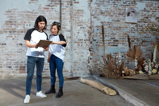 Young event planners collaborating together on set