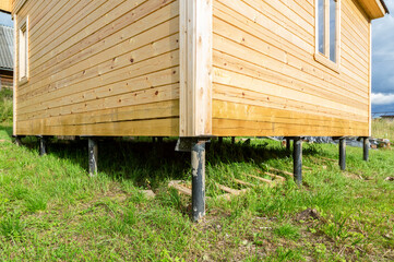 Construction of a new wooden house at the village in summer
