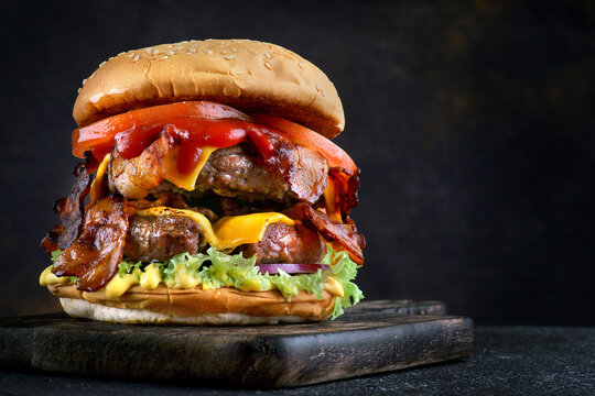 Delicious fresh Burger with double cutlet on a dark background