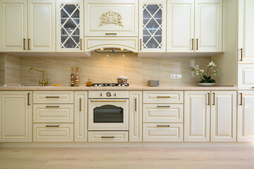 Beige furniture at kitchen in provence style, front view