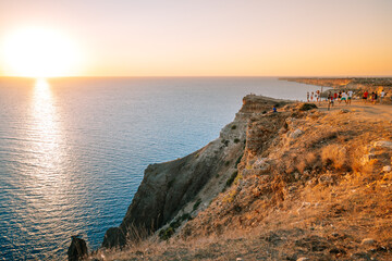 Sevastopol / Crimea - 23 Sep 2020: Crowds of tourists wait for the sunset on the observation deck of Cape Fiolent, a beautiful sea landscape