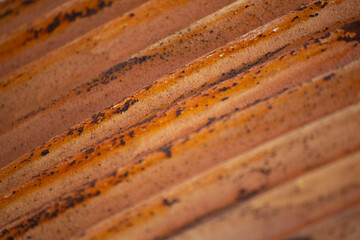 Rusted metal diagonal texture pattern orange color closeup