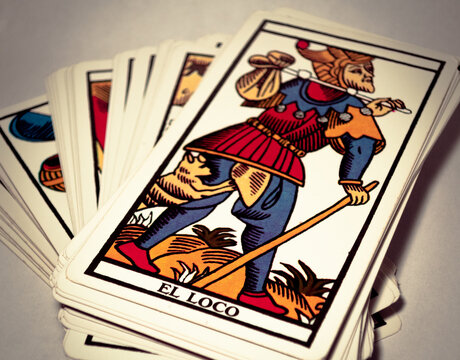 Deck of tarot cards, with the Madman card in the foreground.