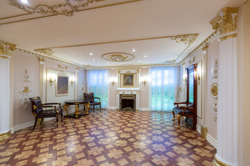 luxurious living room interior with beautiful old carved furniture of gold color with decorations on the walls in the style of the royal palace