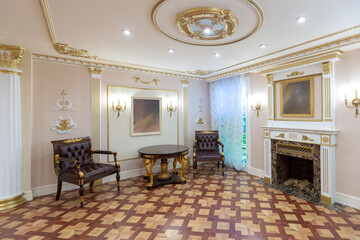 luxurious living room interior with beautiful old carved furniture of gold color with decorations on the walls in the style of the royal palace