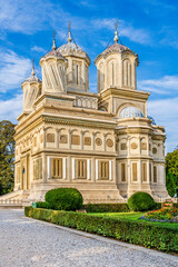 Fototapeta na wymiar Cathedral of Curtea de Arges, a romanian Orthodox cathedral on the grounds of Curtea de Arges Monastery, dedicated to Dormition of the Mother of God in Curtea de Arges, Wallachia, Romania