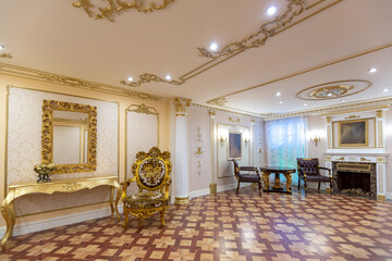 luxurious living room interior with beautiful old carved furniture of gold color with decorations...