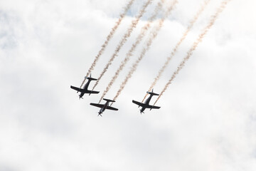 Fighter jets in the sky in airshow against clouds and sky precision flying machines against the sky clouds riding together team work collaboration close 