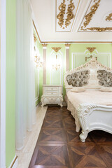 small luxury bedroom with bath and expensive furniture in a chic old baroque style.