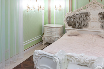 small luxury bedroom with bath and expensive furniture in a chic old baroque style.