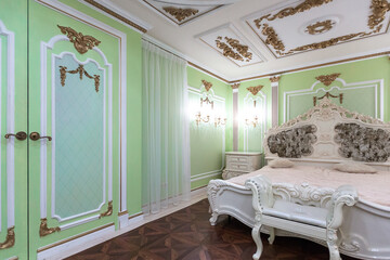 small luxury bedroom with bath and expensive furniture in a chic old baroque style.