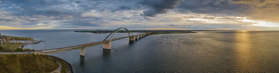 Panorama aerial view of Fehmarn Sound Bridge in sunset (Fehmarnsundbrücke), suspension bridge with...