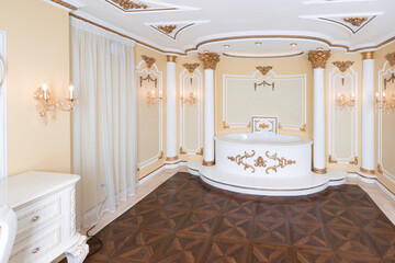small luxury bedroom with bath and expensive furniture in a chic old baroque style.