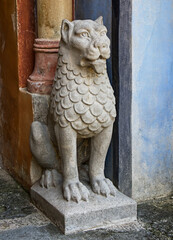Fototapeta na wymiar Lion statue near a passage door. Rocchetta Mattei. Bologna, Italy