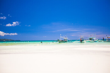Perfect tropical beach with turquoise water and sailboats