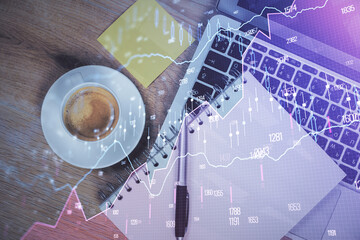 Double exposure of forex chart drawing over table background with computer. Concept of financial...