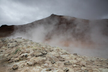 The broad volcanic terrain with bubbling sulphuric pits seen in the Leirhnjukur area of Iceland.