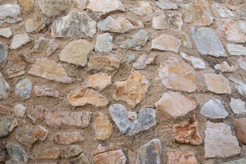 Old stone wall. The texture of the old wall. Masonry. Stone background for design development