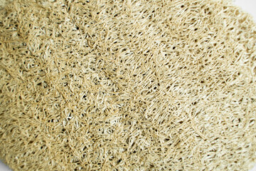 Natural loofah kitchen dish washing sponges. Eco friendly dishwashing sponge on a gray surface, top view. Biodegradable dishwashing scrub pad.