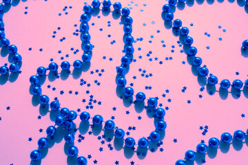 Blue sparkles and stars on pink pastel trendy background.