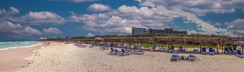 Idyllic tropical beach in Cuba at Santa Clara. Wide angle panoramic view of beach and tourists 