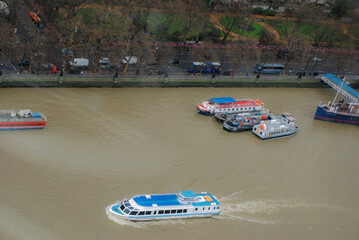 Boats cruising along the River Thames in London, UK