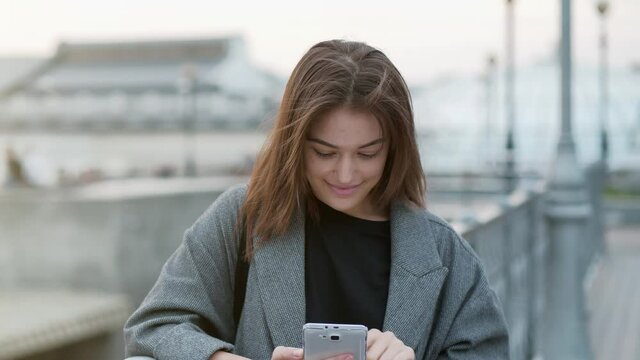 Slow Motion Beautiful woman uses smartphone