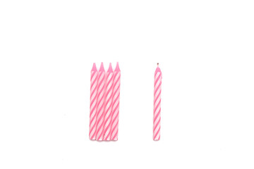 People stay away from you concept. Close up a candle is far from the other candles over white background.