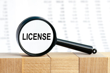 Look closely and License with a magnifying glass , business concept image with soft focus background