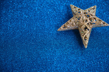 Fototapeta na wymiar Christmas star on a blue glitter background