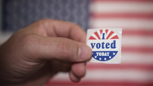 Voting in America - I voted sticker held up proudly by a responsible citizen who played their part in democratic elections