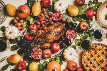 Autumn Thanksgiving, Friendsgiving, family party gathering celebration table setting. Flat-lay of Fall decorated table with roasted duck in seasonal fruits and vegetables and apple pie