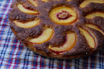 almond pie with peaches with golden crust close up, food photo, delicious