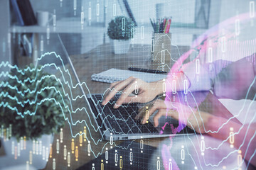 Double exposure of woman hands typing on computer and forex chart hologram drawing. Stock market invest concept.