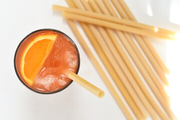 pasta straw in glass and on white table