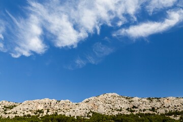 Fototapeta na wymiar Beautiful blue sky and mountains. Brela, Croatia