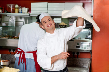 Chef throwing the pizza base dough