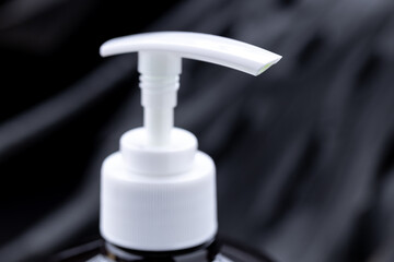 soap dispenser product bottle over dark luxury background. copy space. hygiene washing lifestyles conceptual