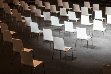 Indoor business conference seating arranged for social distance. COVID-19 health and safety...