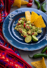 Fresh Guacamole with Ingredients and Tortilla Chips. Traditional Mexican Food. Top View.