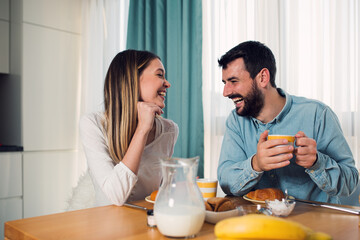 Sweet young couple have a breakfast at home