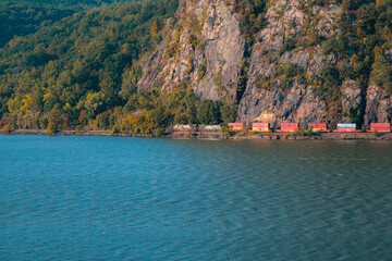Cargo freight train at the base of Storm King Mountain in the Lower Hudson River Valley, as seen from the Breakneck Ridge hiking trail