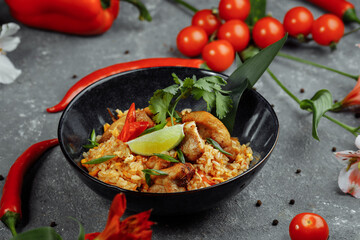 Thai rice with chicken. Thai dish of rice, chicken, Yalta onion, corn, pineapple, tomato, soy sauce, chili paste, cilantro, lime, chili pepper