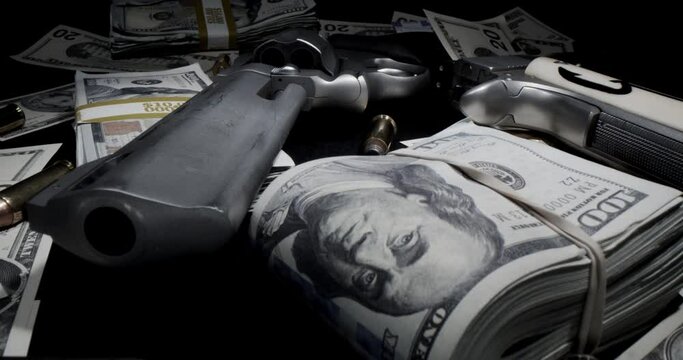Revolver gun with money on a table. Slow pull out revealing guns and money