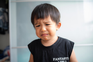 Little boy sad offended crying in house