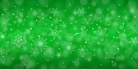 Christmas background of complex big and small falling snowflakes in green colors with bokeh effect