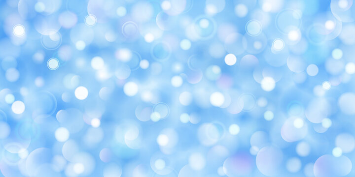 Abstract background of big and small translucent circles in light blue colors with bokeh effect