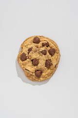 Close up of a classic chocolate chip cookie. Famous and ubiquitous cookie made with candy chocolate chips. Texture and macro shot of a cookie 
